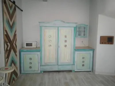 a painting of a blue cabinet in a room at La gota de leche 3 in Sanlúcar de Barrameda