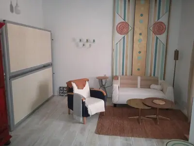 a living room with a couch and a chair at La gota de leche 3 in Sanlúcar de Barrameda