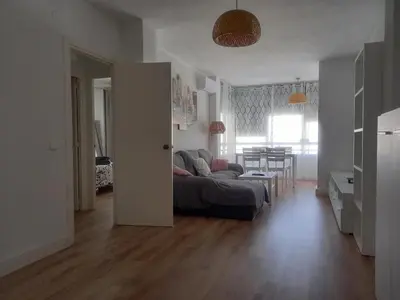 a living room with a couch and a table in a room at Primera línea Valdelagrana in El Puerto de Santa María