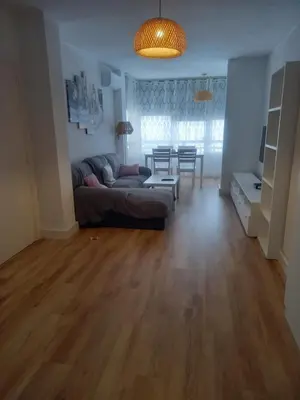 a living room with a couch and a table at Primera línea Valdelagrana in El Puerto de Santa María