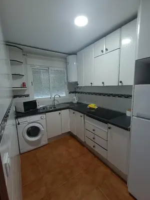 a kitchen with a sink and a washing machine at Apartamento Red de Almadraba in Chiclana de la Frontera