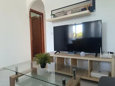 a living room with a large television on a table at Apartamento Red de Almadraba in Chiclana de la Frontera