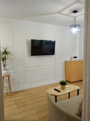a living room with a flat screen tv on a wall at Primera linea playa valdelagrana vistas al mar in El Puerto de Santa María
