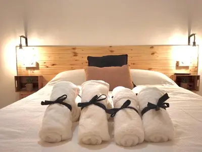 a group of white socks on a bed at Primera linea playa valdelagrana vistas al mar in El Puerto de Santa María