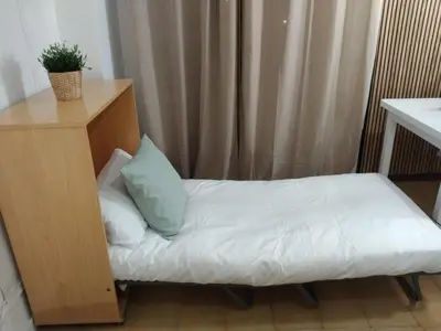a bed with a pillow on it in a room at Primera linea playa valdelagrana vistas al mar in El Puerto de Santa María