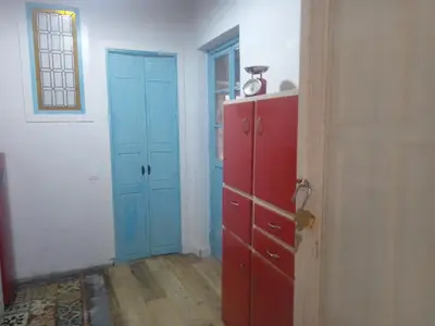a room with two blue doors and a red cabinet at La gota de leche 2 in Sanlúcar de Barrameda
