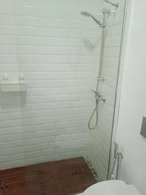a bathroom with a glass shower with a toilet at La gota de leche 2 in Sanlúcar de Barrameda