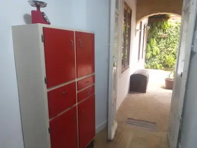 a room with a red dresser and a hallway at La gota de leche 2 in Sanlúcar de Barrameda