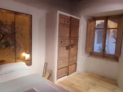 a bedroom with a bed and a window and a door at La gota de leche 2 in Sanlúcar de Barrameda