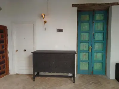 a room with a wooden cabinet and a blue door at La gota de leche 2 in Sanlúcar de Barrameda