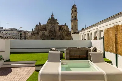 a patio with a table and chairs on a building at Allo Apartments Arroyo Catedral in Jerez de la Frontera