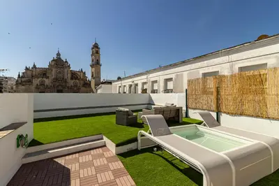 a rooftop garden with a hot tub on a building at Allo Apartments Arroyo Catedral in Jerez de la Frontera