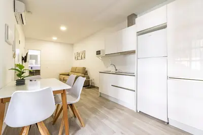 a kitchen and dining room with a table and chairs at Allo Apartments Arroyo Catedral in Jerez de la Frontera