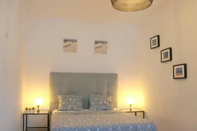 a bedroom with a bed and two tables with lamps at Casa de la Paz / Andalucia in Hozanejos