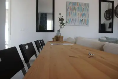a living room with a wooden table and chairs at Casa de la Paz / Andalucia in Hozanejos