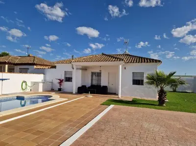 a villa with a swimming pool and a house at Casa de la Paz / Andalucia in Hozanejos