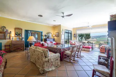 a large living room with a table and chairs at Private Villa Cortijo Sierra y Lago with private swimming pool in Arcos de la Frontera