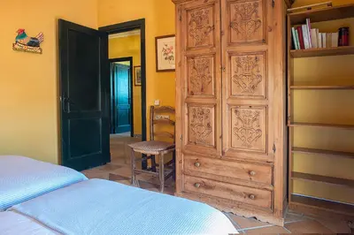 a bedroom with a large wooden cabinet and a bed at Private Villa Cortijo Sierra y Lago with private swimming pool in Arcos de la Frontera