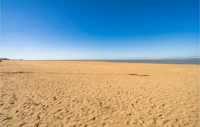 a sandy beach with footprints in the sand at Cozy Apartment In Sanlúcar De Barrameda in Sanlúcar de Barrameda