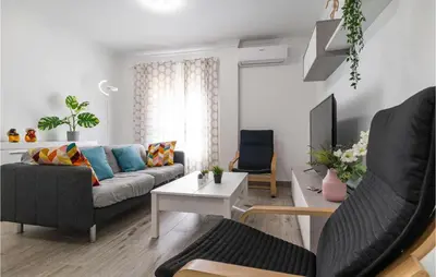 a living room with a couch and a table at Cozy Apartment In Sanlúcar De Barrameda in Sanlúcar de Barrameda