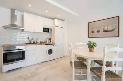 a kitchen with a table and a dining room at Apartoyou - Vistahermosa Bahía in El Puerto de Santa María