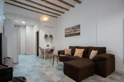 a living room with a couch and a table at Aire del Sur Cádiz in Cádiz
