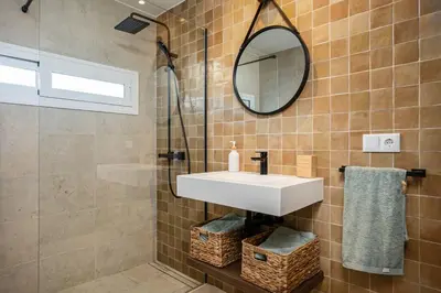 a bathroom with a sink and a mirror at Ocean beachside house with pool 46 in Conil de la Frontera