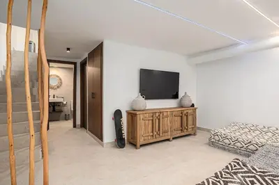 a living room with a television and a couch at Ocean beachside house with pool 46 in Conil de la Frontera
