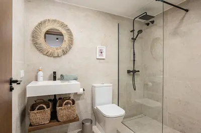 a bathroom with a shower and a toilet and a sink at Ocean beachside house with pool 46 in Conil de la Frontera