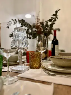a table with glasses and plates and a bottle of wine at La Terraza de Porvenir 10 - Jerez de la Frontera in Jerez de la Frontera