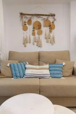 a brown couch with pillows on it in a living room at Zurbarán by Gades Gestión in Cádiz