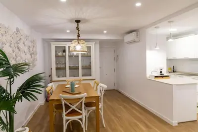 a kitchen and dining room with a table and chairs at Zurbarán by Gades Gestión in Cádiz