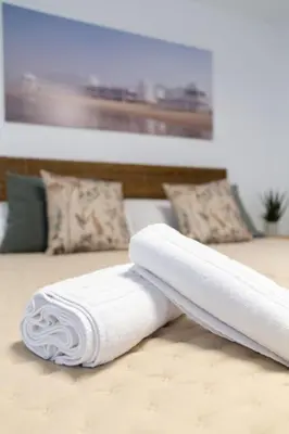 two white towels on a bed with pillows at Zurbarán by Gades Gestión in Cádiz