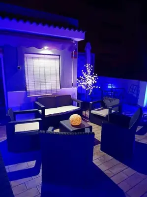 a living room with blue lighting and a christmas tree at casa familiar in San Fernando