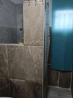 a shower with a glass door in a bathroom at casa familiar in San Fernando