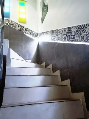 a set of stairs in a room with tiles at casa familiar in San Fernando