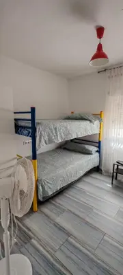 two bunk beds in a room with a fan at casa familiar in San Fernando