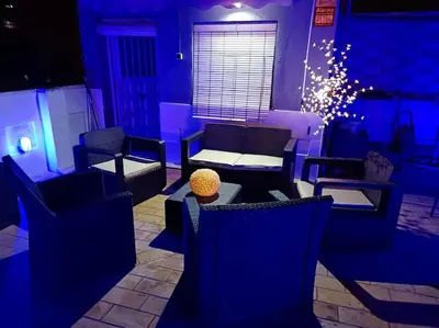 a blue room with chairs and a table and a window at casa familiar in San Fernando