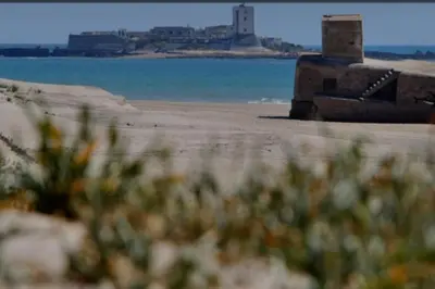 a view of a beach with a lighthouse in the distance at casa familiar in San Fernando