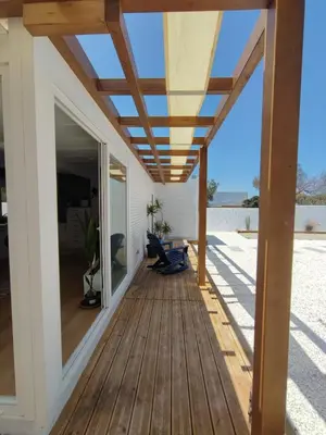 a deck with a pergola on a house at TITO MIGUEL VILLAGE in Chiclana de la Frontera