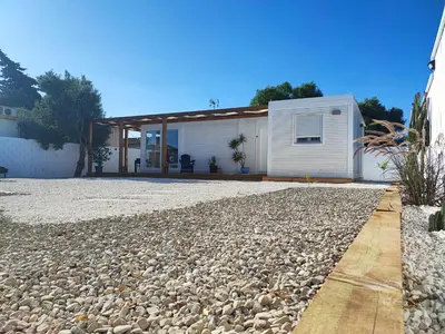 a house with a gravel driveway in front of it at TITO MIGUEL VILLAGE in Chiclana de la Frontera