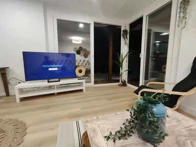 a living room with a flat screen tv on a stand at TITO MIGUEL VILLAGE in Chiclana de la Frontera