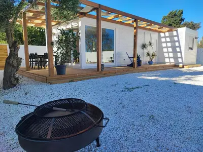 a backyard with a bbq grill and a house at TITO MIGUEL VILLAGE in Chiclana de la Frontera