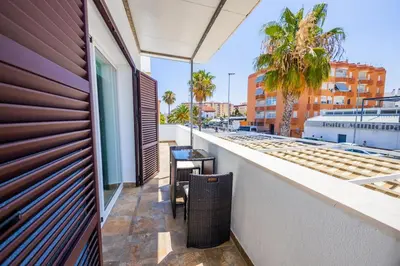 an alley with potted plants on the side of a building at GuestReady - Sanlucar Piletas Beach in Sanlúcar de Barrameda