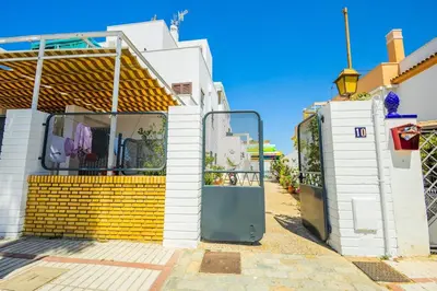 a bedroom with a white bed with two pillows at GuestReady - Sanlucar Piletas Beach in Sanlúcar de Barrameda