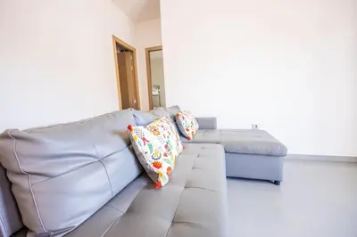 a couch in a living room with pillows on it at GuestReady - Sanlucar Piletas Beach in Sanlúcar de Barrameda