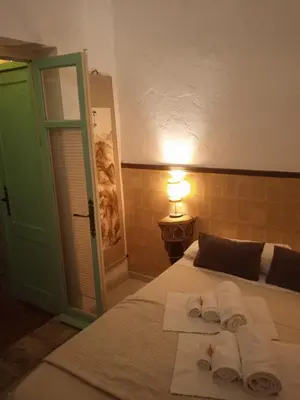 a bedroom with a bed with towels on it at La gota de leche 4 in Sanlúcar de Barrameda