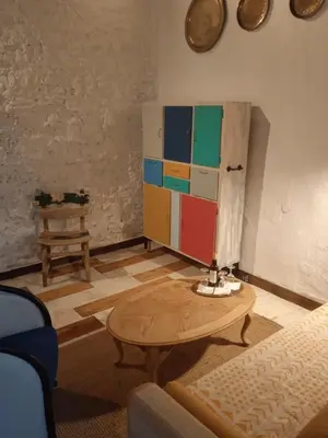 a living room with a table and a cabinet at La gota de leche 4 in Sanlúcar de Barrameda