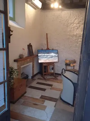 a living room with a television and a fireplace at La gota de leche 4 in Sanlúcar de Barrameda