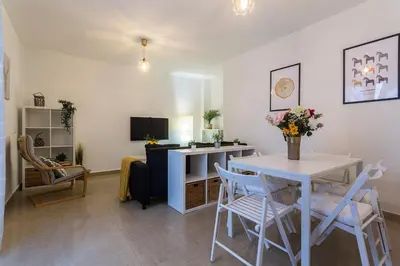 a living room with a table and a couch at Cruz Vieja Centrico 3 Rooms in Jerez de la Frontera